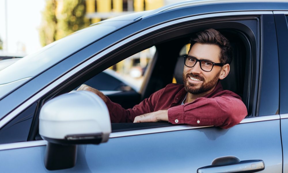 Portrait,Of,Happy,,Handsome,Latin,Man,,Driver,Wearing,Eyeglasses,Sitting